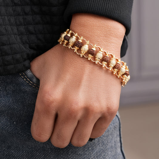 Golden modern beaded men's bracelet worn on wrist with gold and brown beads